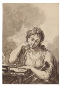 Jeune femme accoudée à sa table de travail
